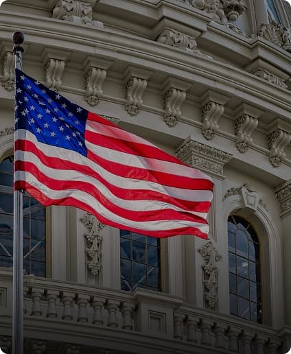 American flag waves in front of the Capitol, symbolizing a call to action for better recycling systems.