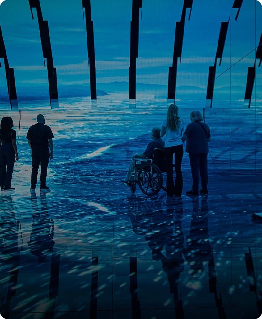 Visitors at the Blue Paradox exhibit learning about the ocean plastic crisis and its impact.