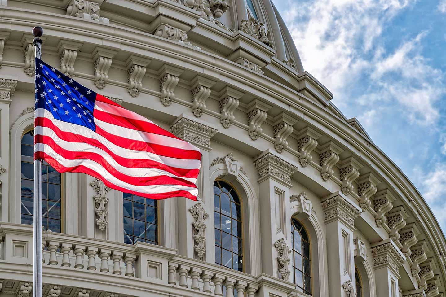 Photo of the United States Capitol building and United States flag.