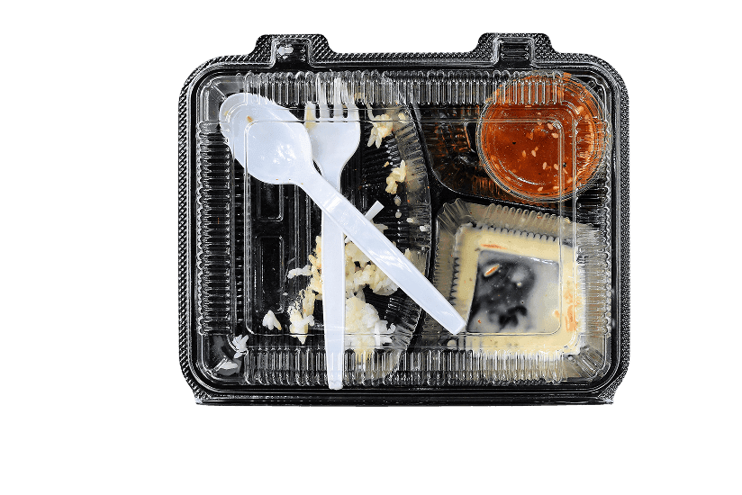 Used plastic food container and utensils highlighting challenges in recycling and need for reuse solutions.