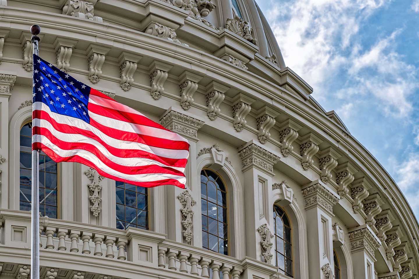 Photo of the United States Capitol building and United States flag.