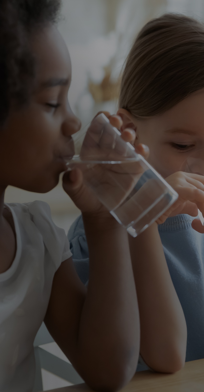 Kids drinking water may unknowingly ingest microplastics from contaminated sources.