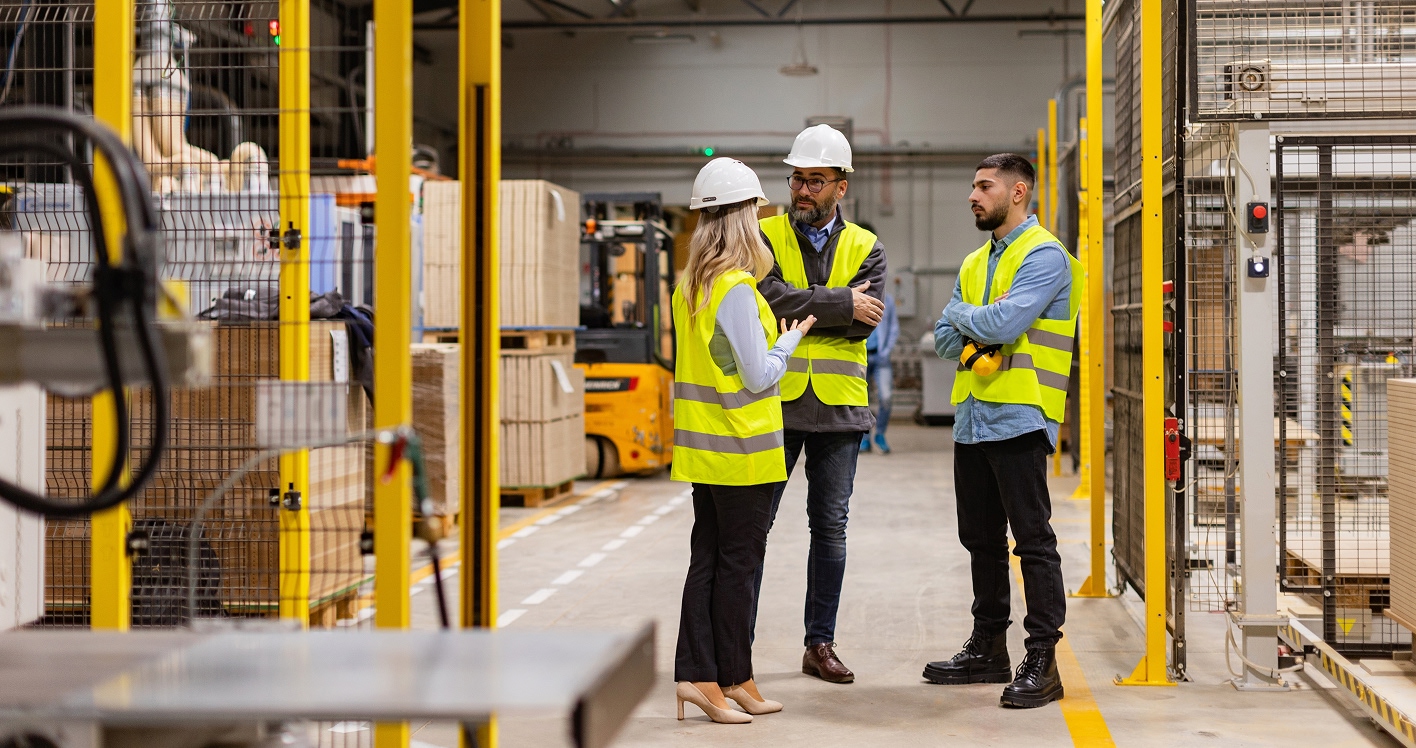 Factory workers discuss strategies for reducing plastic packaging waste.